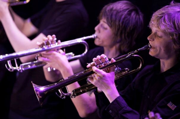 Trumpeters playing the trumpet in an orchestra.